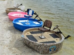 A row of roundabout watercrafts sitting on the shoreline