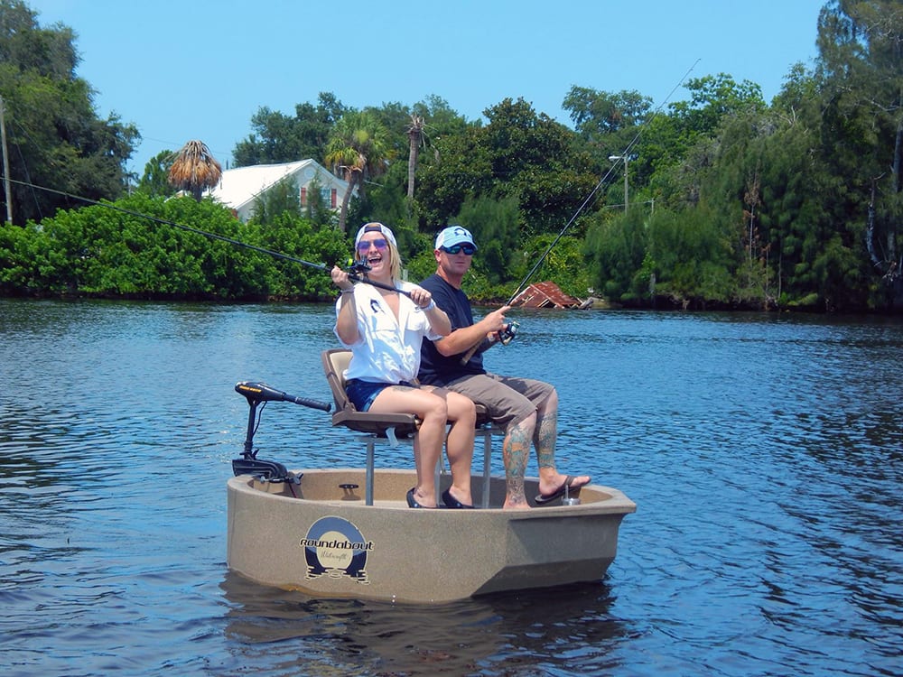 friends fishing from a round boat with a two seat option